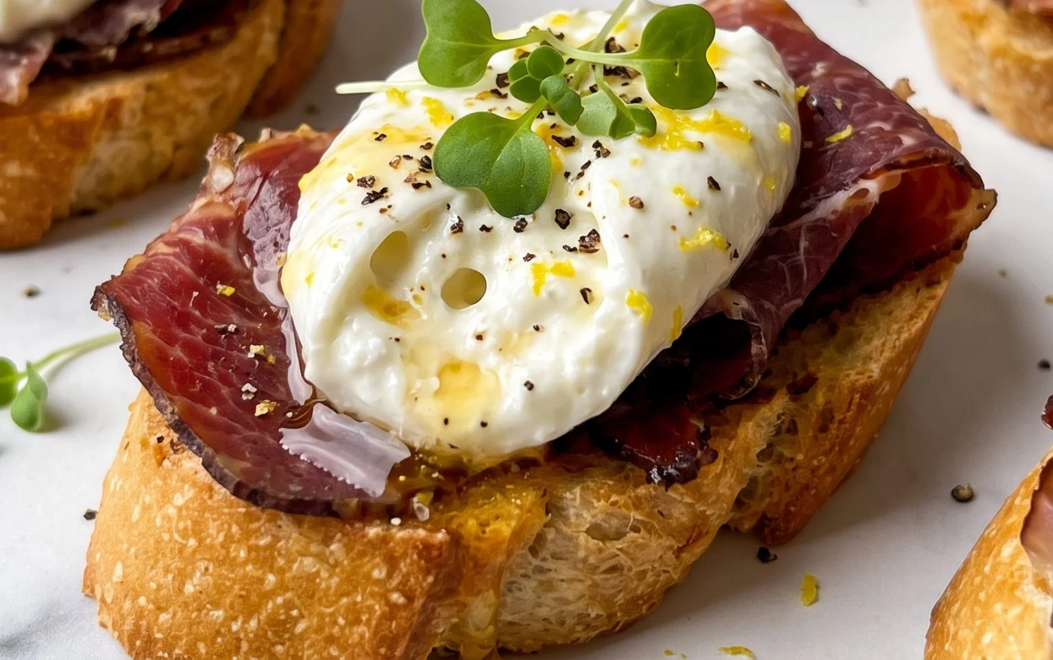 Beef Prosciutto Crostini with Burrata and Lemon Honey Drizzle